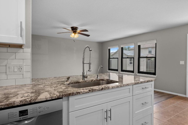 141 Snowy Egret Ln, Leander, TX 78641 - kitchen with dishwasher, a sink, white cabinetry, light stone counters, and ceiling fan