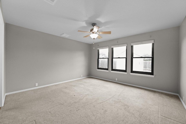 unfurnished room with ceiling fan, carpet flooring, and baseboards