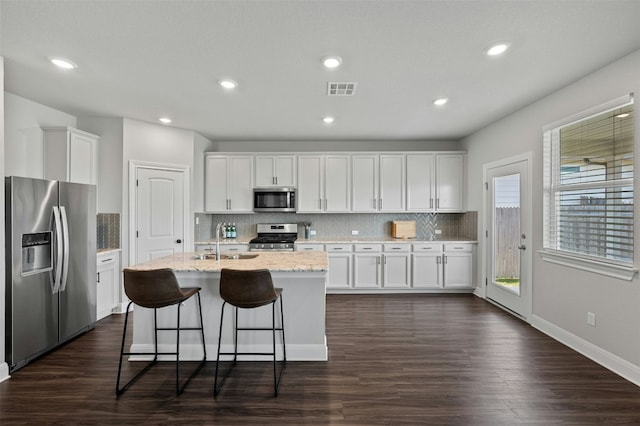 142 Dome Peak Ter, Dripping Springs, TX 78620 - kitchen featuring appliances with stainless steel finishes, white cabinets, tasteful backsplash, dark wood-style flooring, and recessed lighting