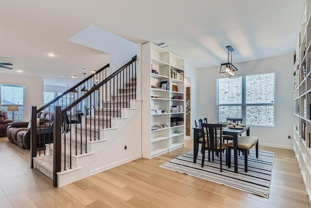 206 Monteforte Rd, Hutto, TX 78634 - dining room with light wood finished floors, stairs, baseboards, a ceiling fan, and recessed lighting