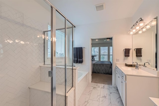 206 Monteforte Rd, Hutto, TX 78634 - ensuite bathroom featuring vanity, a garden tub, a shower stall, and marble look tile flooring