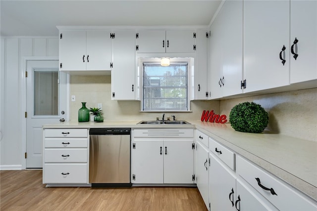 1408 Kent St, Taylor, TX 76574 - kitchen with dishwasher, a sink, light wood-style flooring, light countertops, and white cabinetry