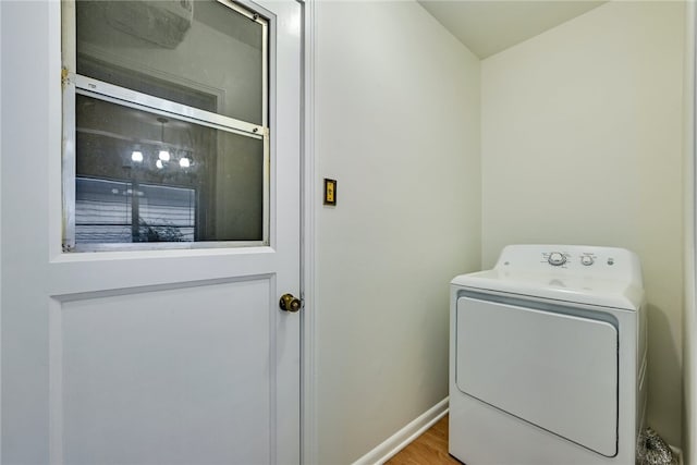 1408 Kent St, Taylor, TX 76574 - clothes washing area with washer / dryer, baseboards, and wood finished floors