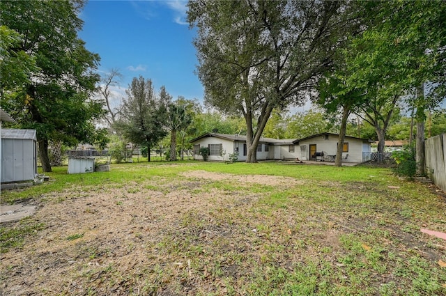 1408 Kent St, Taylor, TX 76574 - view of yard with a storage unit and an outbuilding