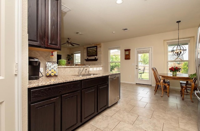 112 Moulins Ln, Georgetown, TX 78626 - kitchen with a sink, stainless steel dishwasher, tasteful backsplash, a peninsula, and dark brown cabinets