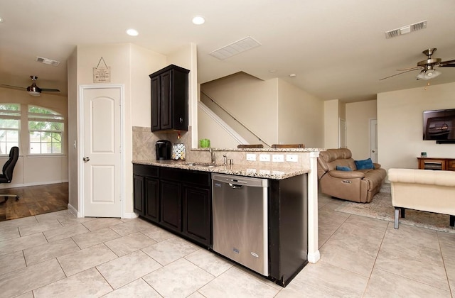 112 Moulins Ln, Georgetown, TX 78626 - kitchen featuring dishwasher, ceiling fan, open floor plan, a peninsula, and light stone countertops