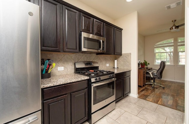 112 Moulins Ln, Georgetown, TX 78626 - kitchen featuring appliances with stainless steel finishes, a ceiling fan, decorative backsplash, dark brown cabinetry, and recessed lighting
