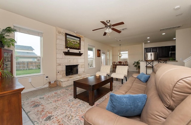112 Moulins Ln, Georgetown, TX 78626 - living area featuring a ceiling fan, baseboards, a fireplace, light tile patterned floors, and recessed lighting