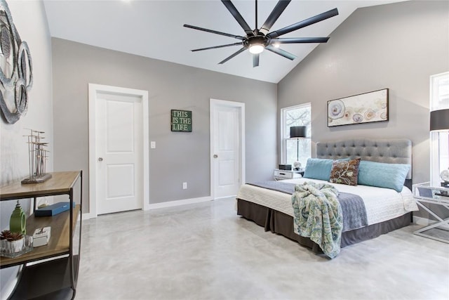 bedroom with baseboards, high vaulted ceiling, finished concrete floors, and a ceiling fan