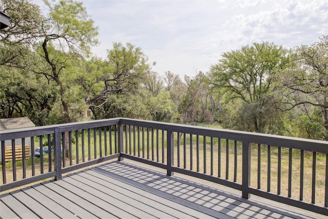 wooden terrace with view of wooded area