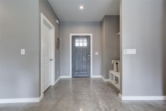 entrance foyer featuring finished concrete floors and baseboards