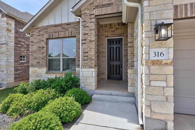 316 Barrel Bnd, Georgetown, TX 78628 - doorway to property with board and batten siding, brick siding, and stone siding