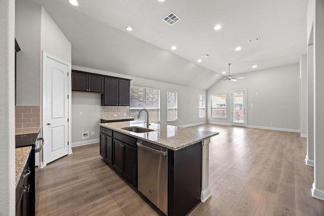 316 Barrel Bnd, Georgetown, TX 78628 - kitchen with stainless steel appliances, lofted ceiling, decorative backsplash, light wood-style floors, and a kitchen island with sink