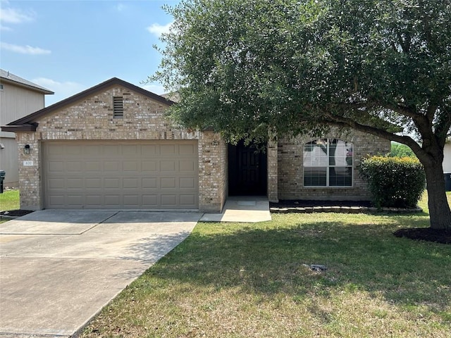 670 Covent Dr, Kyle, TX 78640 - view of front of property with an attached garage, brick siding, a front yard, and driveway