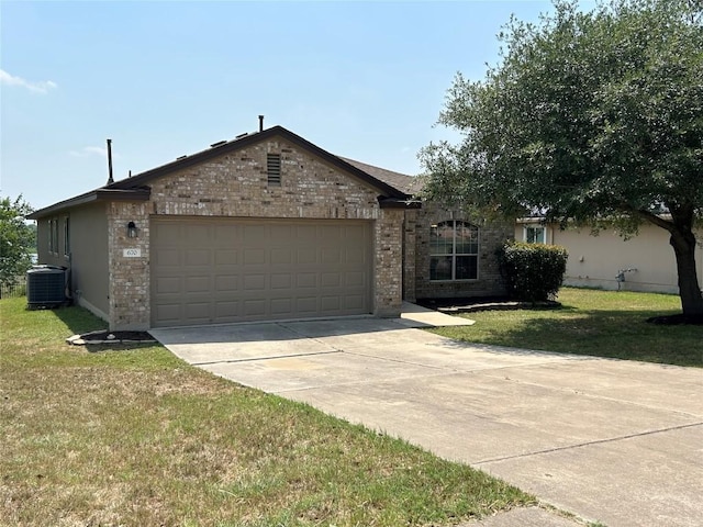 670 Covent Dr, Kyle, TX 78640 - single story home featuring central air condition unit, an attached garage, a front yard, and driveway