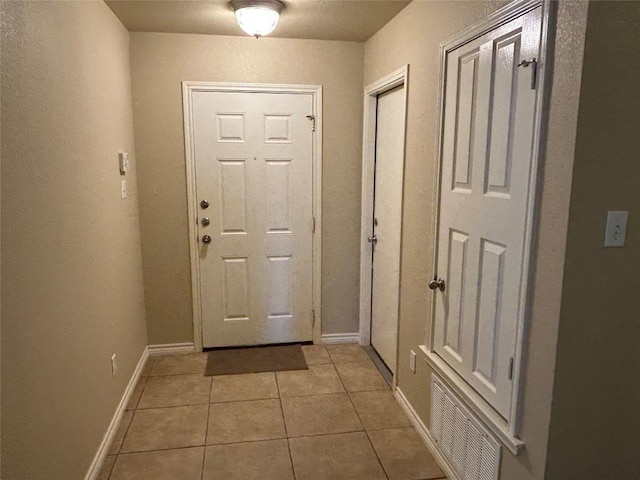 670 Covent Dr, Kyle, TX 78640 - entryway featuring light tile patterned floors and baseboards