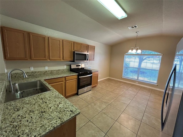 670 Covent Dr, Kyle, TX 78640 - kitchen with stainless steel appliances, a sink, vaulted ceiling, a chandelier, and light tile patterned flooring