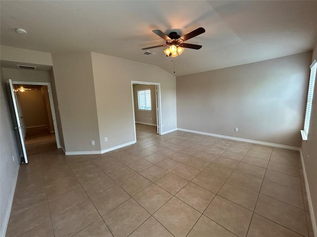 670 Covent Dr, Kyle, TX 78640 - unfurnished room with a ceiling fan, light tile patterned floors, baseboards, and lofted ceiling
