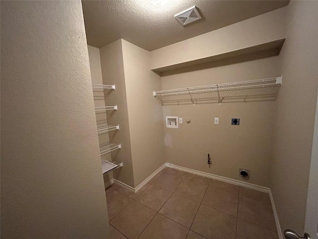 670 Covent Dr, Kyle, TX 78640 - washroom with gas dryer hookup, hookup for an electric dryer, washer hookup, baseboards, and tile patterned flooring