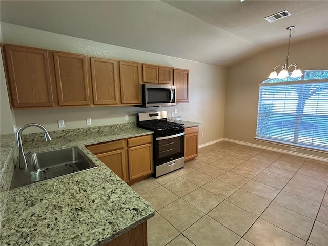 670 Covent Dr, Kyle, TX 78640 - kitchen with stainless steel appliances, vaulted ceiling, a sink, light tile patterned floors, and a chandelier