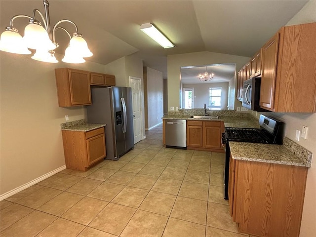 670 Covent Dr, Kyle, TX 78640 - kitchen featuring appliances with stainless steel finishes, a chandelier, a sink, vaulted ceiling, and light tile patterned floors