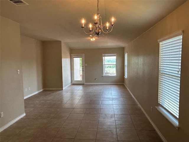 670 Covent Dr, Kyle, TX 78640 - empty room featuring a chandelier, tile patterned floors, and baseboards