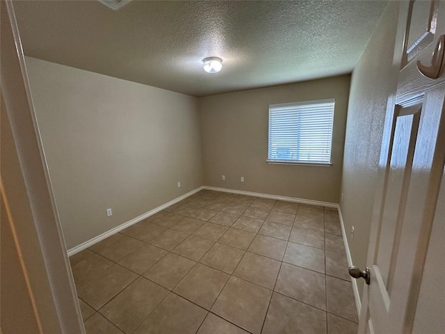 670 Covent Dr, Kyle, TX 78640 - tiled empty room with a textured ceiling and baseboards