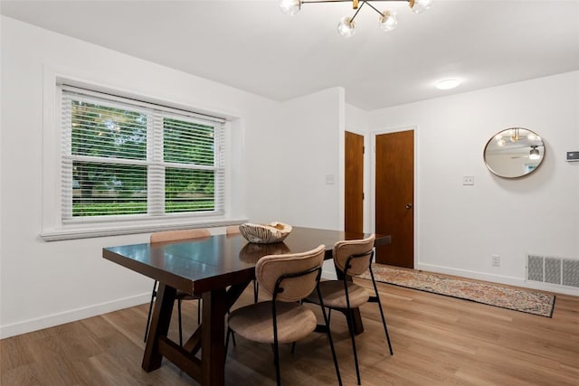 6309 Middleham Pl, Austin, TX 78745 - dining space featuring wood finished floors and a chandelier