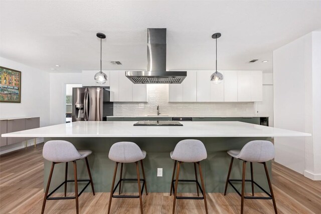 6309 Middleham Pl, Austin, TX 78745 - kitchen with stainless steel fridge with ice dispenser, wall chimney exhaust hood, modern cabinets, and white cabinetry