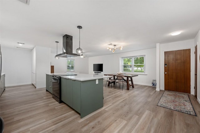 6309 Middleham Pl, Austin, TX 78745 - kitchen with wall chimney range hood, black / electric stove, light countertops, and light wood-style flooring