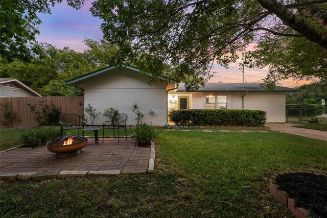 6309 Middleham Pl, Austin, TX 78745 - view of front of house with an outdoor fire pit, a patio, and brick siding
