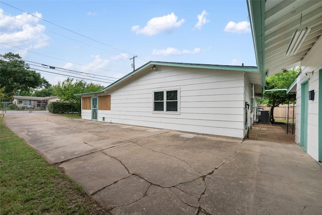 6309 Middleham Pl, Austin, TX 78745 - view of side of home with a patio and driveway