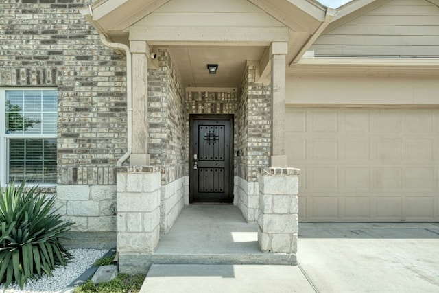 3209 Ortman Dr, Pflugerville, TX 78660 - doorway to property with an attached garage, stone siding, and driveway