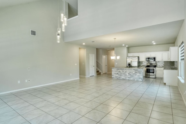 3209 Ortman Dr, Pflugerville, TX 78660 - unfurnished living room featuring stairs, recessed lighting, light tile patterned floors, baseboards, and a high ceiling