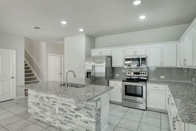 3209 Ortman Dr, Pflugerville, TX 78660 - kitchen featuring stainless steel appliances, a sink, decorative backsplash, white cabinets, and recessed lighting