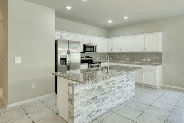 3209 Ortman Dr, Pflugerville, TX 78660 - kitchen featuring stainless steel appliances, a sink, decorative backsplash, white cabinetry, and light stone counters