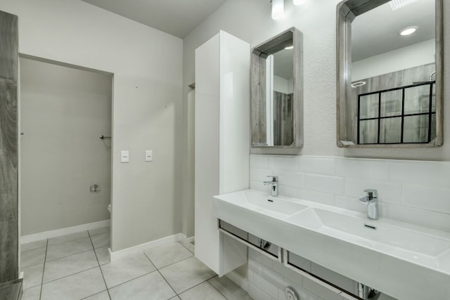 3209 Ortman Dr, Pflugerville, TX 78660 - bathroom with tile patterned floors, double vanity, backsplash, and baseboards
