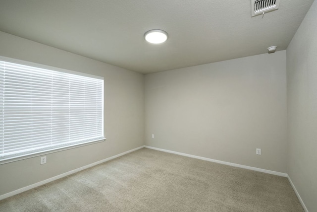 3209 Ortman Dr, Pflugerville, TX 78660 - empty room featuring light carpet, baseboards, and a smoke detector