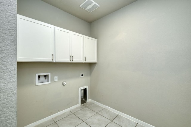 3209 Ortman Dr, Pflugerville, TX 78660 - washroom featuring cabinet space, hookup for an electric dryer, gas dryer hookup, light tile patterned floors, and baseboards