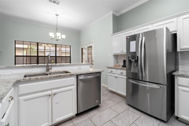 2317 Sycamore Trl, Round Rock, TX 78664 - kitchen featuring stainless steel appliances, decorative backsplash, a chandelier, white cabinetry, and ornamental molding