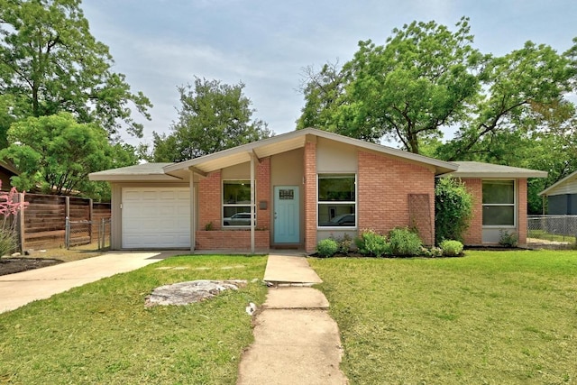 6209 Peggy St, Austin, TX 78723 - mid-century home with a garage, driveway, and brick siding