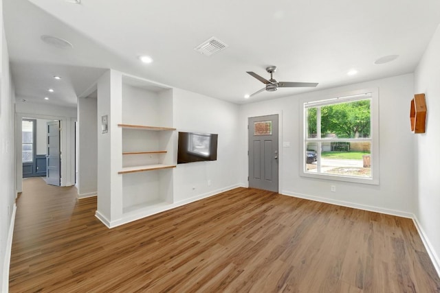6209 Peggy St, Austin, TX 78723 - unfurnished living room featuring wood finished floors, a ceiling fan, and recessed lighting