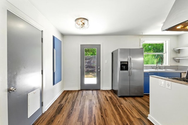 6209 Peggy St, Austin, TX 78723 - kitchen with stainless steel fridge, wall chimney range hood, dark wood-type flooring, and plenty of natural light