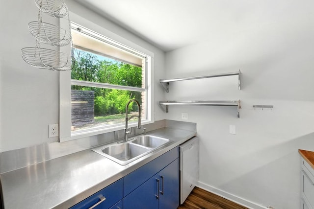 6209 Peggy St, Austin, TX 78723 - kitchen with dishwasher, blue cabinets, dark wood finished floors, and light countertops