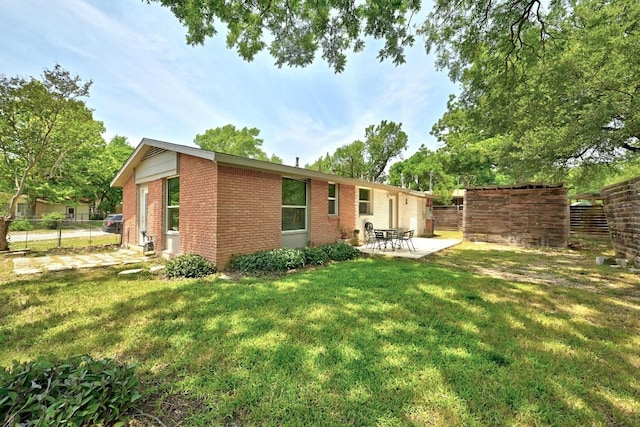 6209 Peggy St, Austin, TX 78723 - rear view of property with brick siding, a patio, and an attached garage