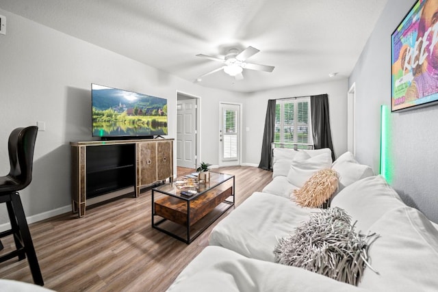 517 SW Pkwy Unit 104, College Station, TX 77840 - living area featuring a ceiling fan, baseboards, and wood finished floors