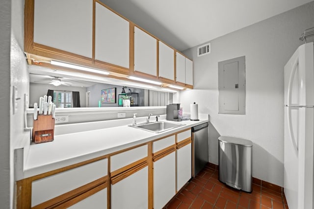 517 SW Pkwy Unit 104, College Station, TX 77840 - kitchen featuring freestanding refrigerator, a sink, dishwasher, electric panel, and brick floors