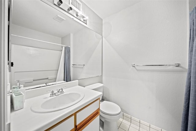 517 SW Pkwy Unit 104, College Station, TX 77840 - full bath with toilet, tile patterned flooring, vanity, and a shower with shower curtain