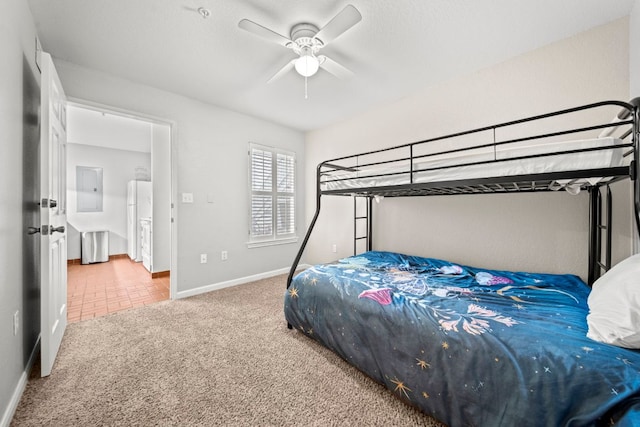 517 SW Pkwy Unit 104, College Station, TX 77840 - bedroom with carpet flooring, baseboards, freestanding refrigerator, and a ceiling fan