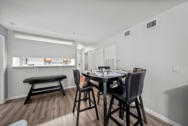 517 SW Pkwy Unit 104, College Station, TX 77840 - dining space with wood finished floors and baseboards